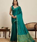 green silk blend saree with gold zari border and striped pallu
