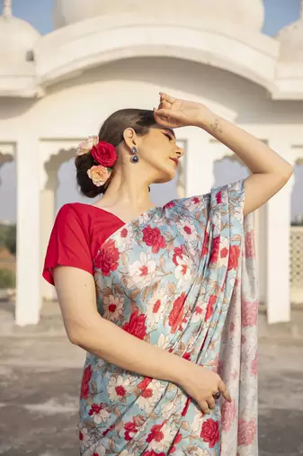 light blue floral printed satin saree with red blouse piece