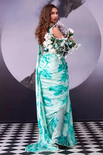 rama green satin saree with printed leaf motifs