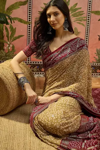 Beige georgette bandhni saree with unstitched blouse piece