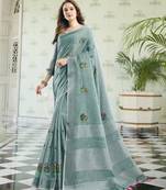 women sea green linen saree with floral embroidery border & tassels