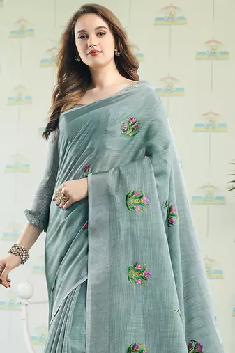 women sea green linen saree with floral embroidery border & tassels