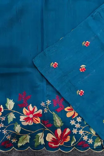 Teal matka silk saree with heavy floral embroidery border with running blouse