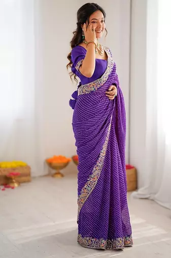 Purple color faux georgette bandhni print & embroidered border saree