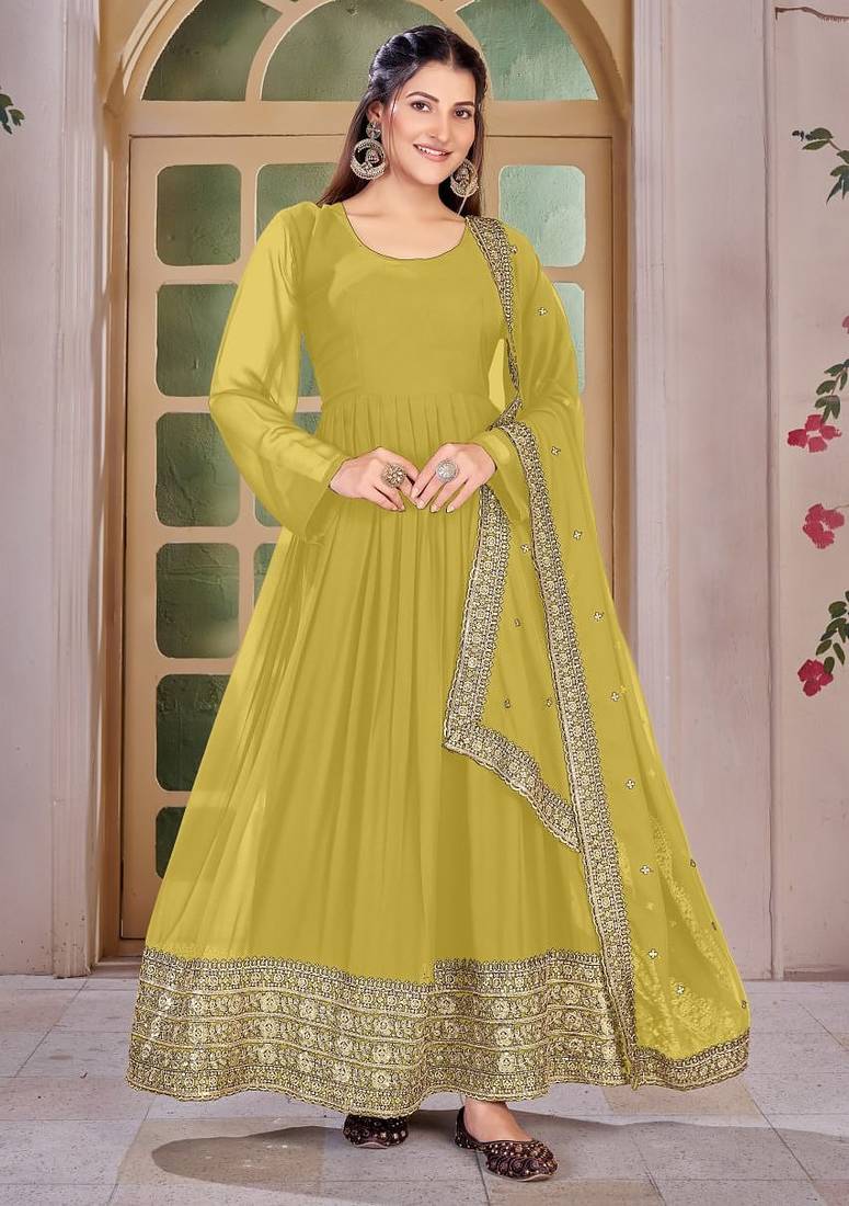 Woman's yellow festival long gown with embroidery sequnce work