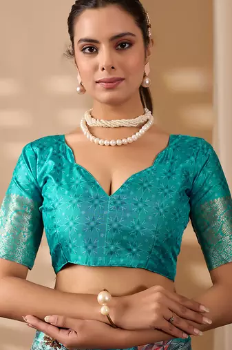 Turquoise green lichi silk saree with abstract & floral digital print and rich zari woven border with designer blouse