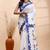 White & blue handloom saree with intricate applique work and floral artistic border