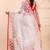 White & red muslin saree with delicate jamdani motifs and graceful contrast border
