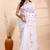 White handloom cotton saree with delicate red and golden floral buti and artistic woven pallu