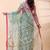 Sea green dual toned muslin saree with delicate jamdani motifs and graceful contrast border