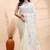 Ivory handloom cotton saree with delicate blue and golden floral buti and artistic woven pallu