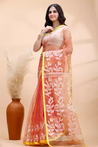 Coral dual toned muslin saree with delicate jamdani motifs and graceful contrast border
