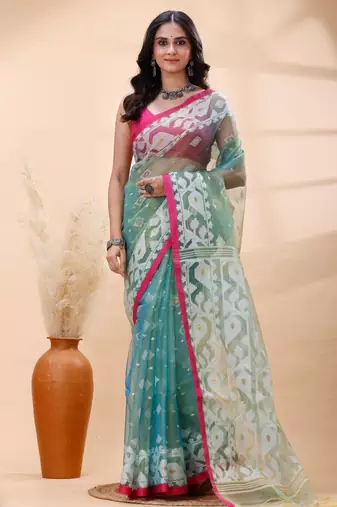 Sea green dual toned muslin saree with delicate jamdani motifs and graceful contrast border