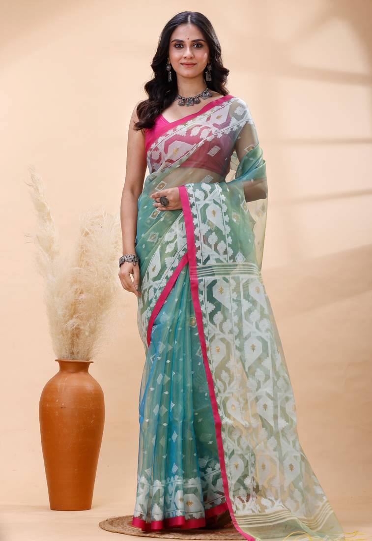 Sea green dual toned muslin saree with delicate jamdani motifs and graceful contrast border