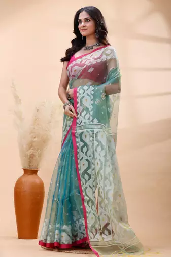 Sea green dual toned muslin saree with delicate jamdani motifs and graceful contrast border