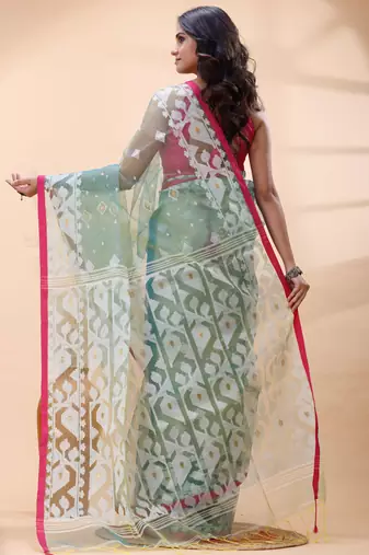 Sea green dual toned muslin saree with delicate jamdani motifs and graceful contrast border