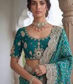 Turquoise Color Embroidered Lace,Dori,Multi Thread And Zari With Sequins And Zircon Diamond Work Banarasi Silk Saree