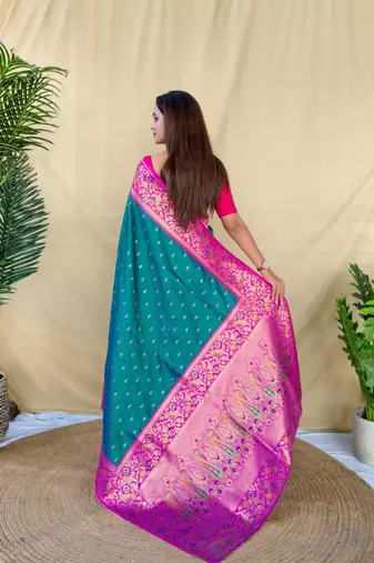 teal green soft silk saree adorned with delicate zari woven buttas