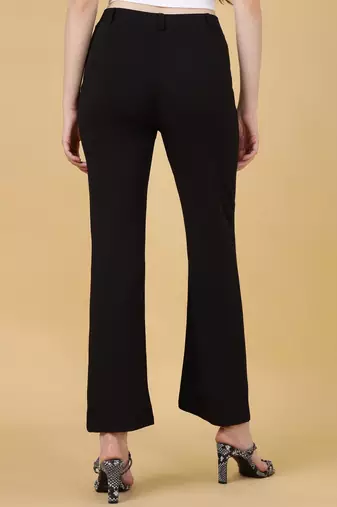 Women solid black regular fit mid-rise flat front trousers