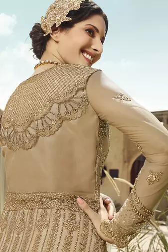 Soft premium net wedding wear gown in golden with embroidery & stone work