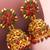 Aadita Traditional Gold-Tone Kundan Jhumka Earrings with Pink and Green Stones