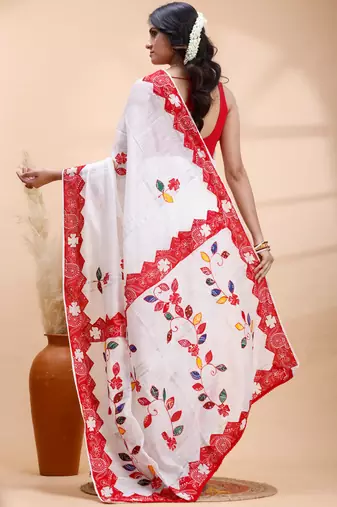 White & red handloom saree with intricate applique work and floral artistic border