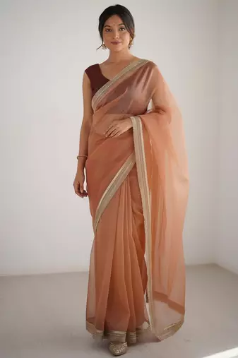 Peach net embellished saree with contrast blouse piece