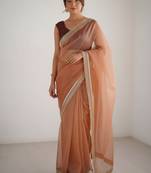 Peach net embellished saree with contrast blouse piece