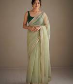 Lighte green net embellished saree with contrast blouse piece