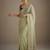 Lighte green net embellished saree with contrast blouse piece