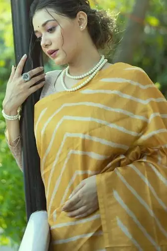 Yellow color tussar silk blend lehariya printed zari border saree