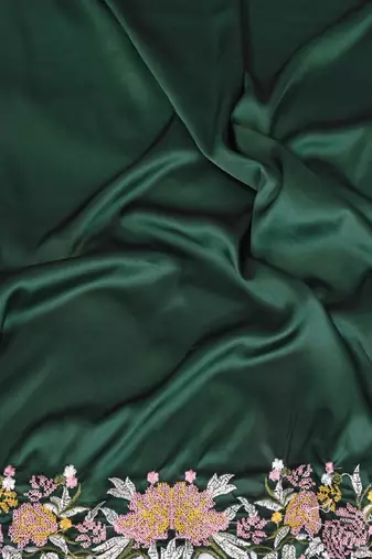 Green soft satin saree with embroidered border and matching blouse piece