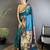 Women teal floral & meena weaving lichi silk saree