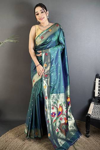 Women teal parrot & floral woven design lichi silk saree