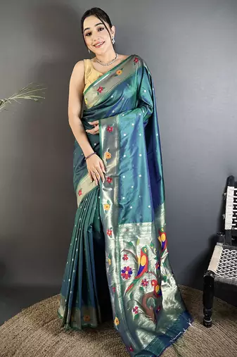 Women teal parrot & floral woven design lichi silk saree