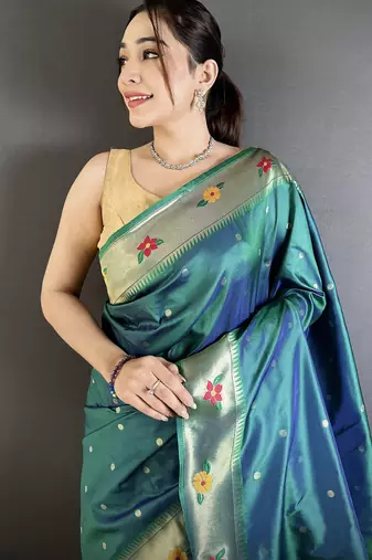 Women teal parrot & floral woven design lichi silk saree