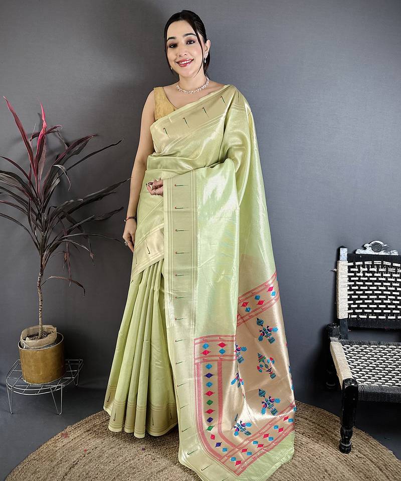 Women light green solid tissue saree