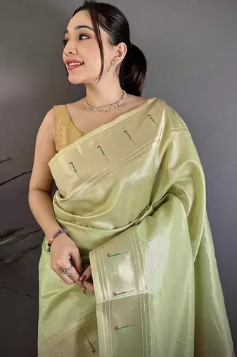Women light green solid tissue saree