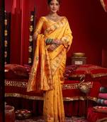 Women light orange floral motifs silk blend saree