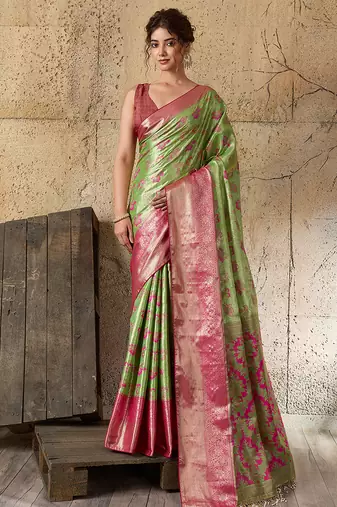 Women's green silk blend saree with rich zari woven design and traditional border with unstiched blouse piece