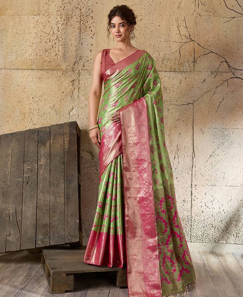Women's green silk blend saree with rich zari woven design and traditional border with unstiched blouse piece