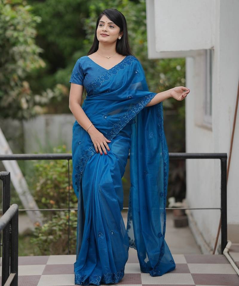 Teal embroidered blouse with embroidered saree