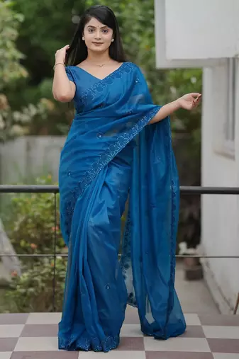 Teal embroidered blouse with embroidered saree