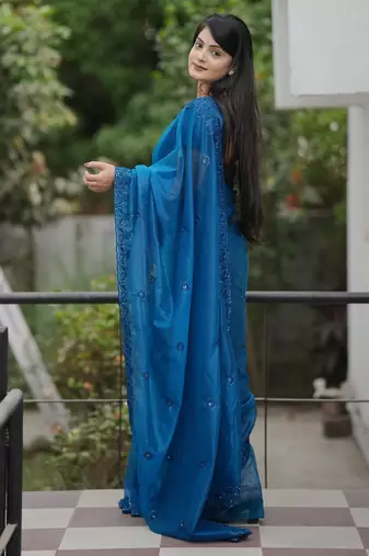 Teal embroidered blouse with embroidered saree
