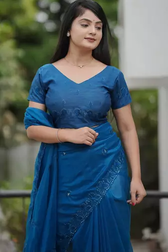 Teal embroidered blouse with embroidered saree