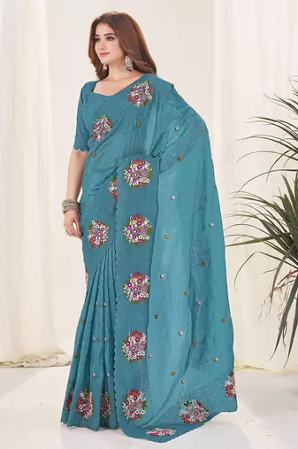 Teal embroidered blouse with embroidered saree