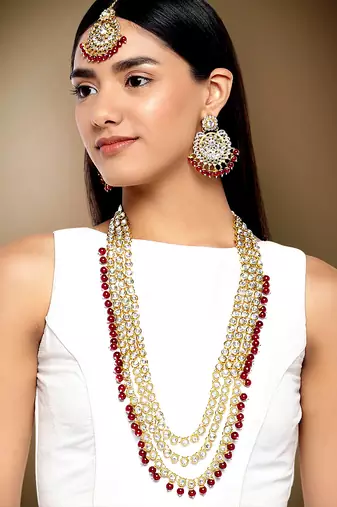 Aheli gold-plated brass and kundan necklace with mang tika & earrings jewellery set