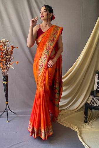 Orange  paithani woven design saree and has a zari border blouse piece
