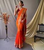 Orange  paithani woven design saree and has a zari border blouse piece
