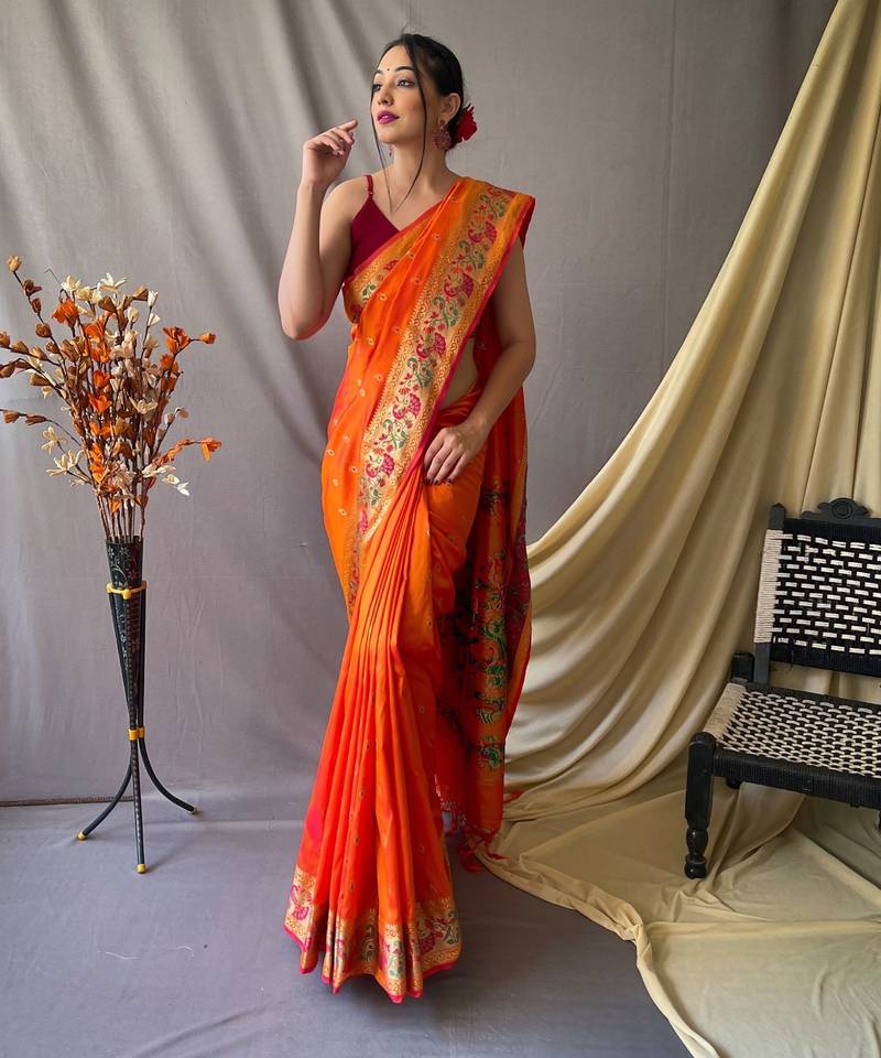 Orange  paithani woven design saree and has a zari border blouse piece